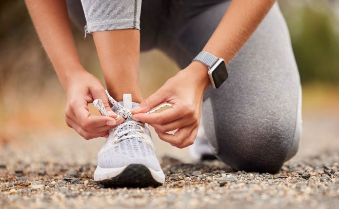 woman tying shoelaces