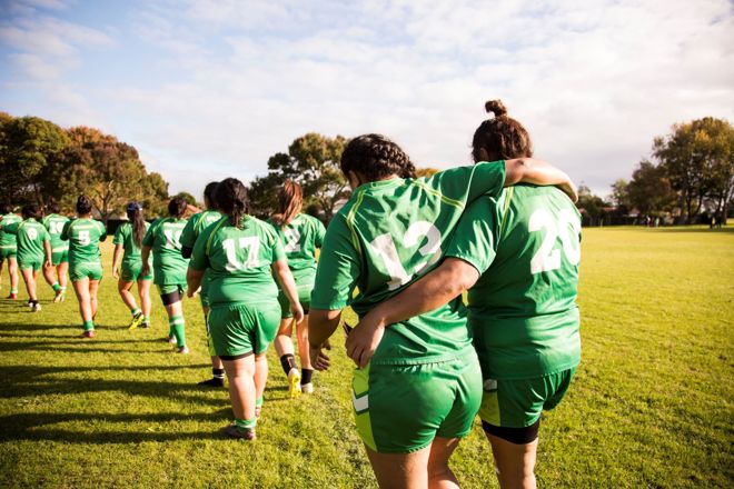 women playing football game